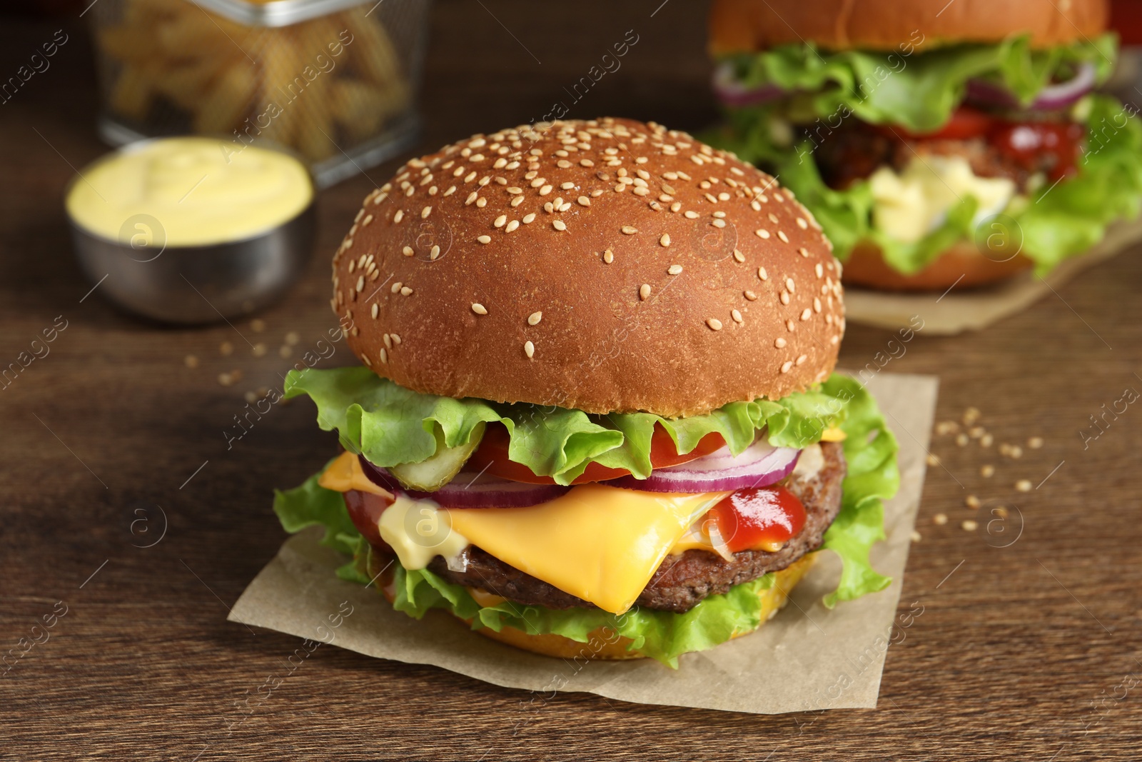 Photo of Delicious burgers with beef patty on wooden table