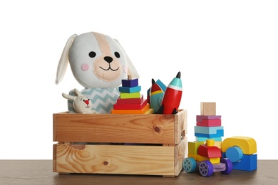 Photo of Set of different toys on wooden table against white background