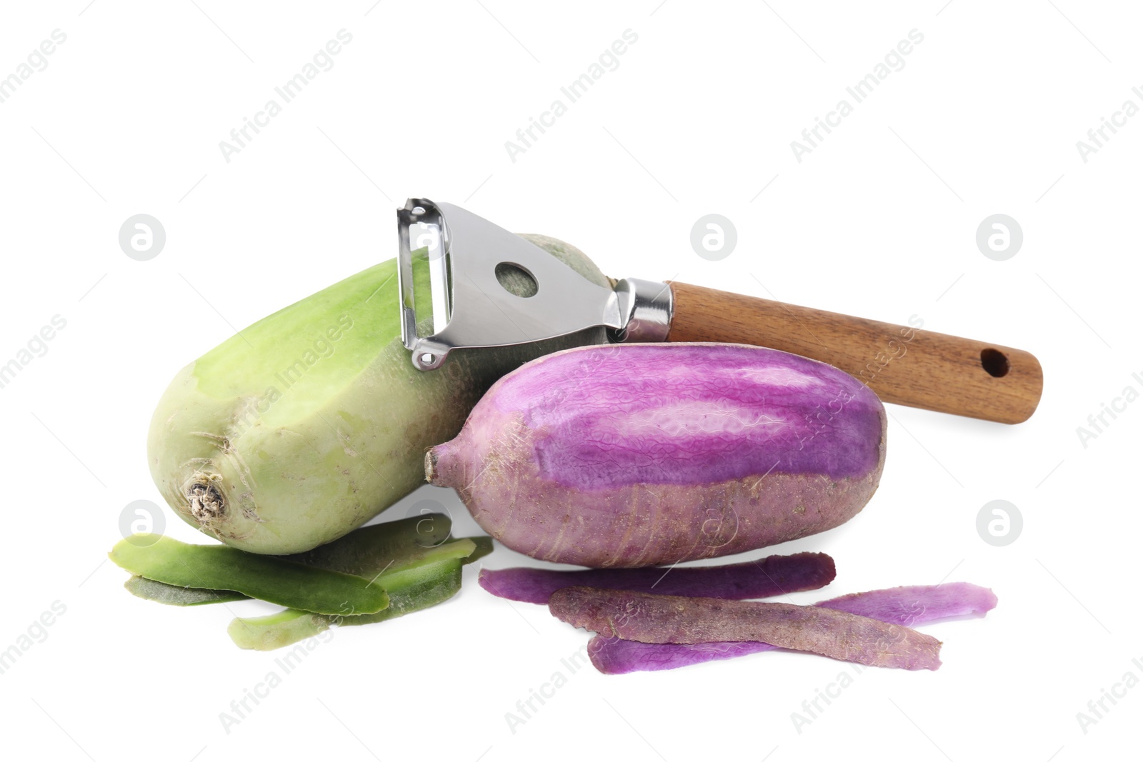 Photo of Daikon radishes and peeler isolated on white