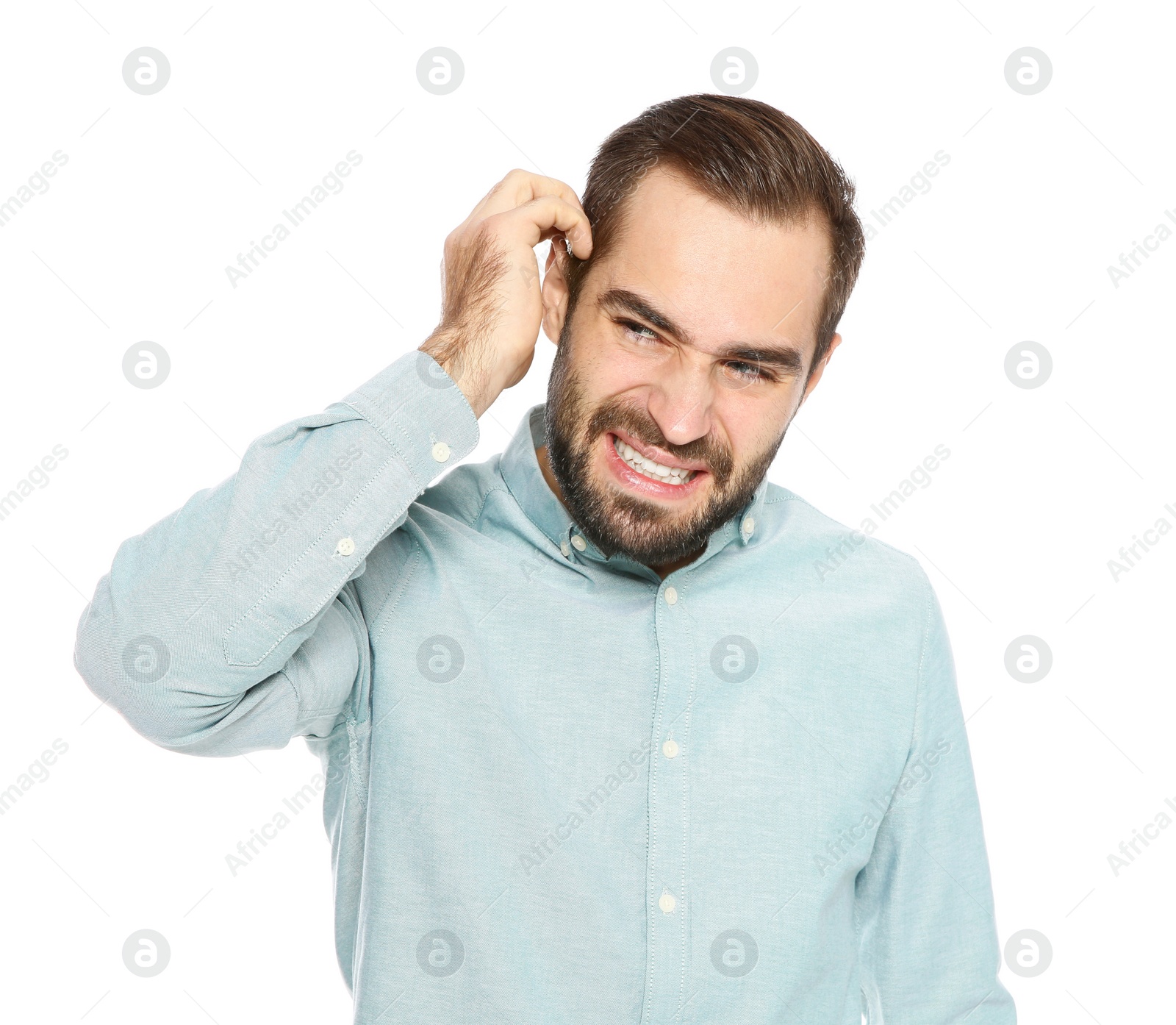 Photo of Young man scratching head on white background. Annoying itch