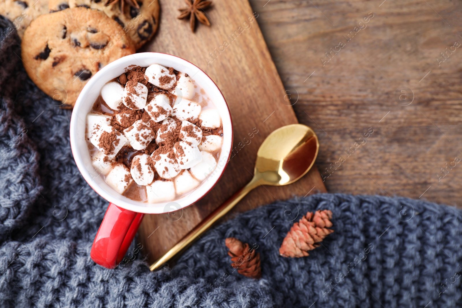 Photo of Flat lay composition of tasty cocoa with marshmallows on wooden table. Space for text