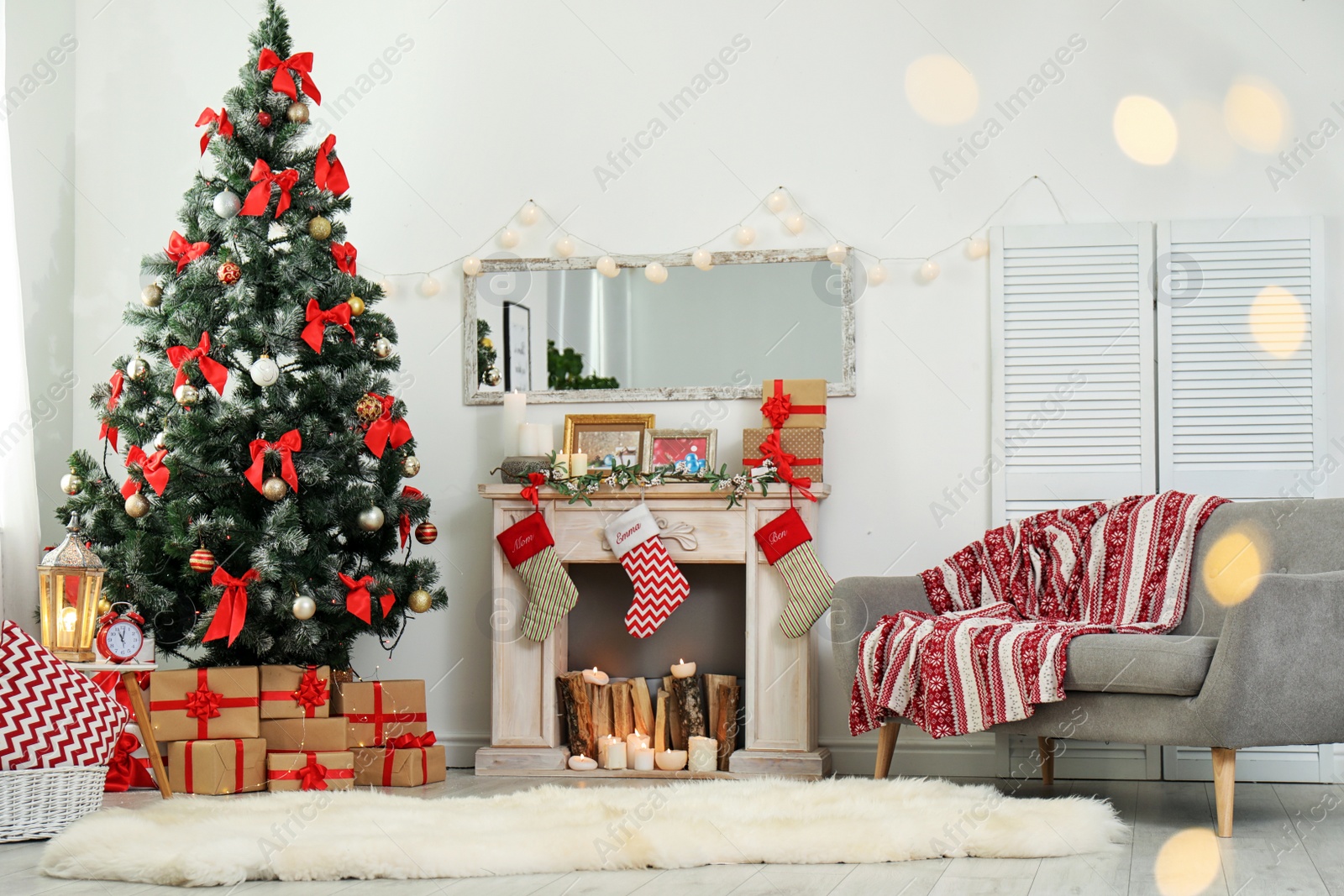 Photo of Stylish living room interior with decorated Christmas tree and blurred lights in foreground