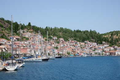 Beautiful view of coastal city with boats on sunny day