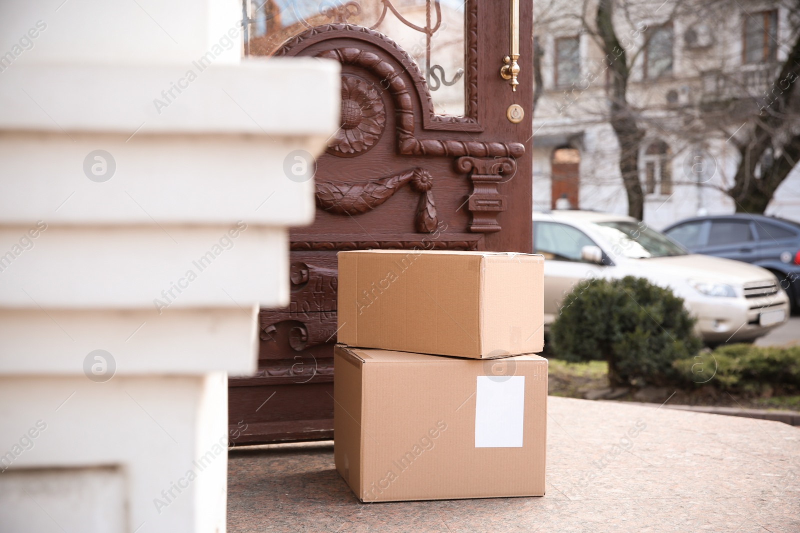 Photo of Delivered parcel boxes near open entrance door