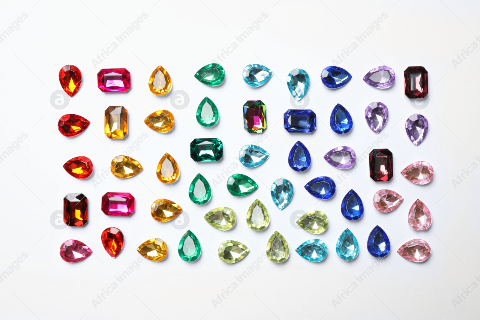 Photo of Different beautiful gemstones on white background, top view