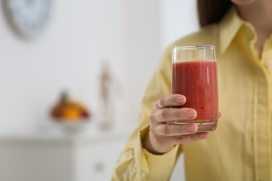 Photo of Woman with delicious smoothie at home, closeup. Space for text