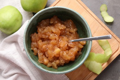 Photo of Delicious apple jam and fresh fruits on grey table, flat lay