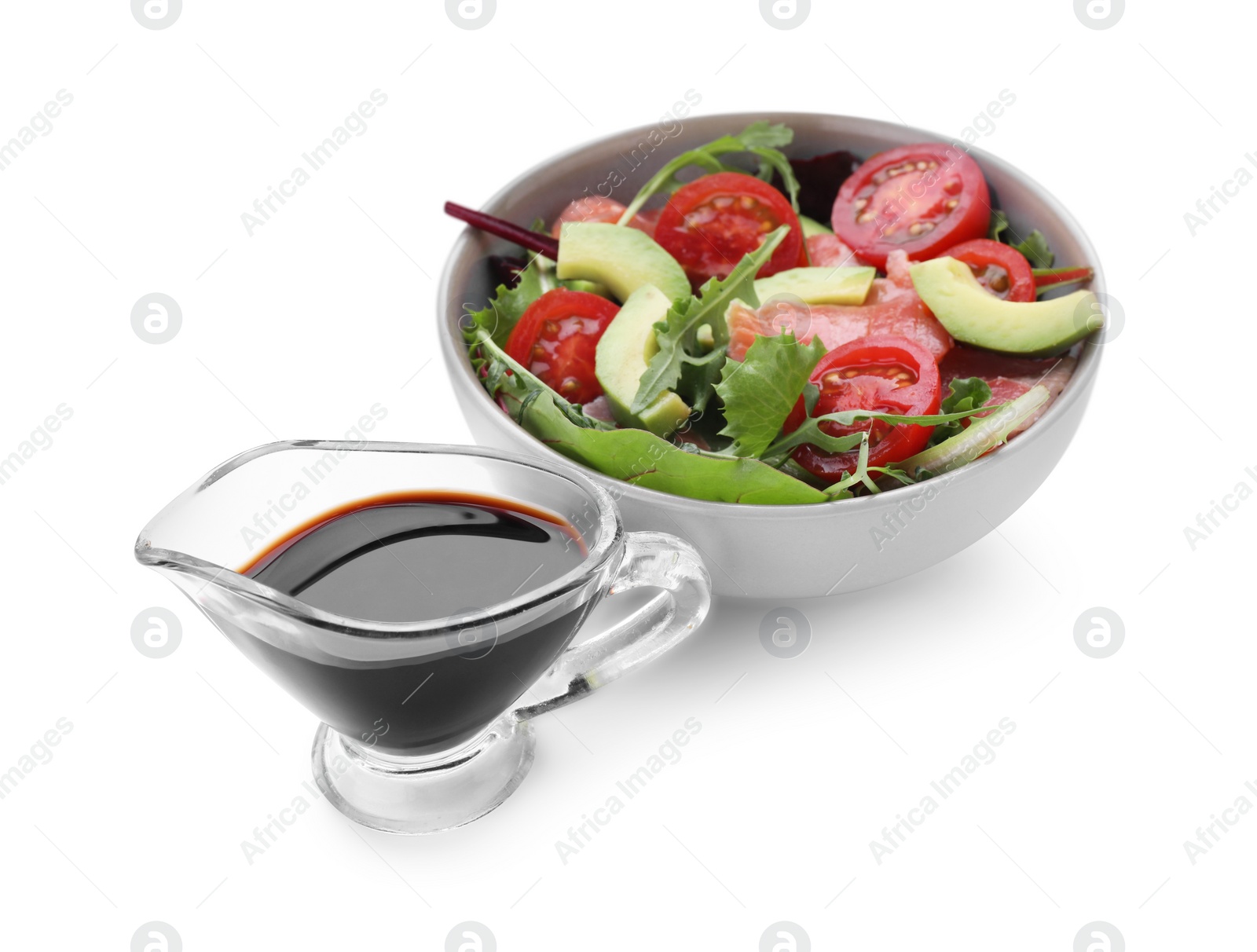 Photo of Tasty soy sauce and bowl with salad isolated on white