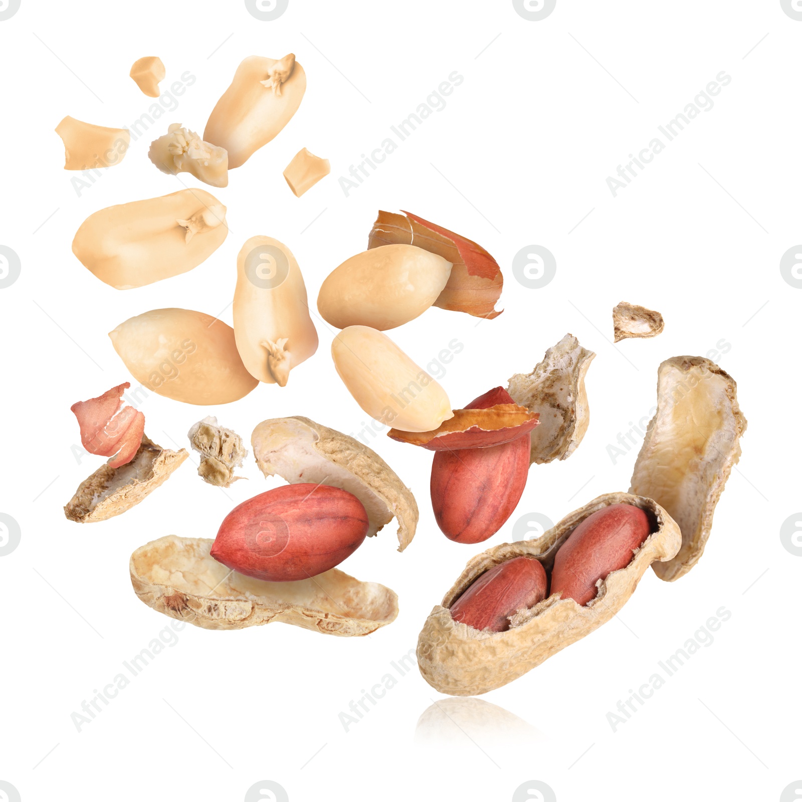 Image of Peanuts and crushed pods in air on white background