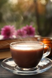 Glass cup with coffee on wooden table. Morning ritual