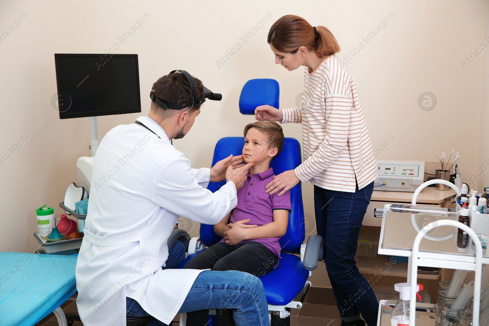 Photo of Woman with her child visiting otolaryngologist in hospital