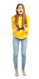 Emotional young woman playing video games with controller isolated on white