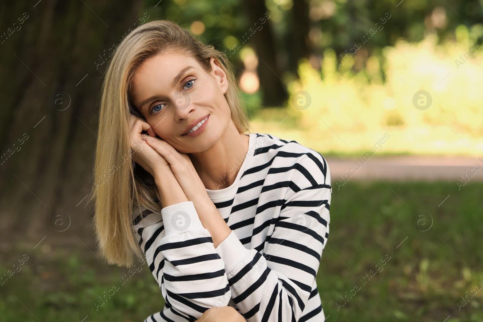 Photo of Portrait of happy woman in casual clothes outdoors. Space for text. Attractive lady posing for camera