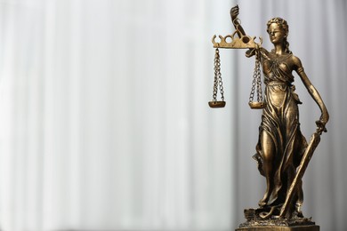 Photo of Figure of Lady Justice indoors, space for text. Symbol of fair treatment under law
