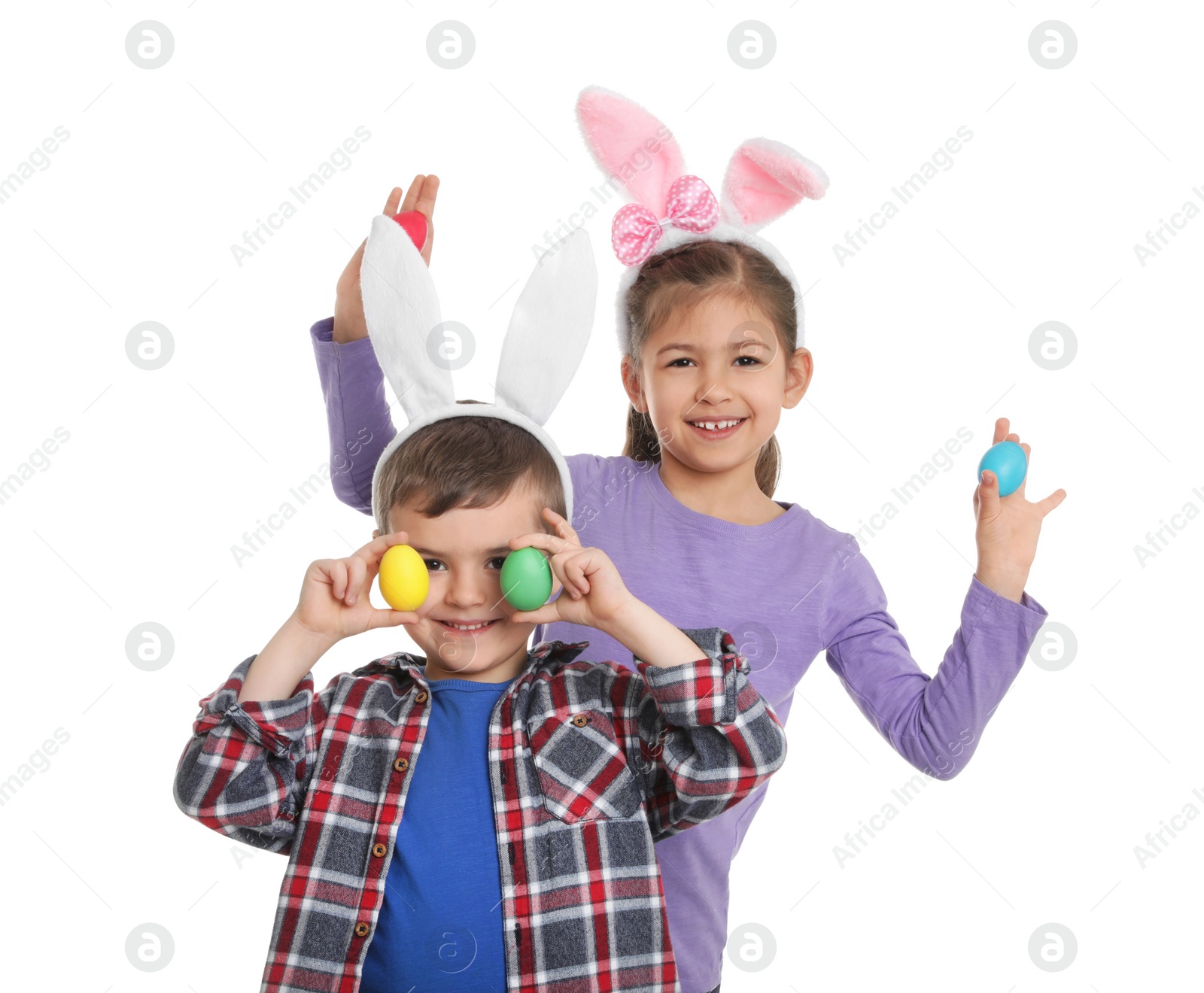 Photo of Cute children in bunny ears headbands with Easter eggs on white background
