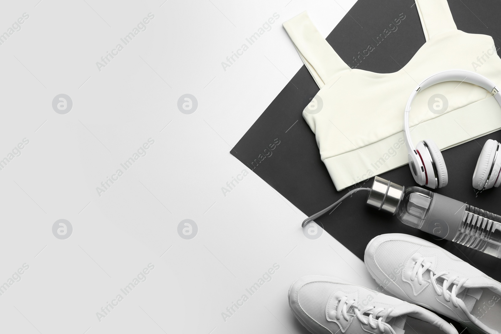 Photo of Flat lay composition with sportswear and equipment on light grey background, space for text. Gym workout