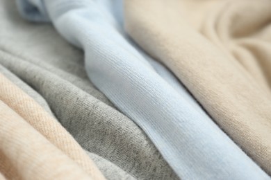 Photo of Different cashmere clothes as background, closeup view