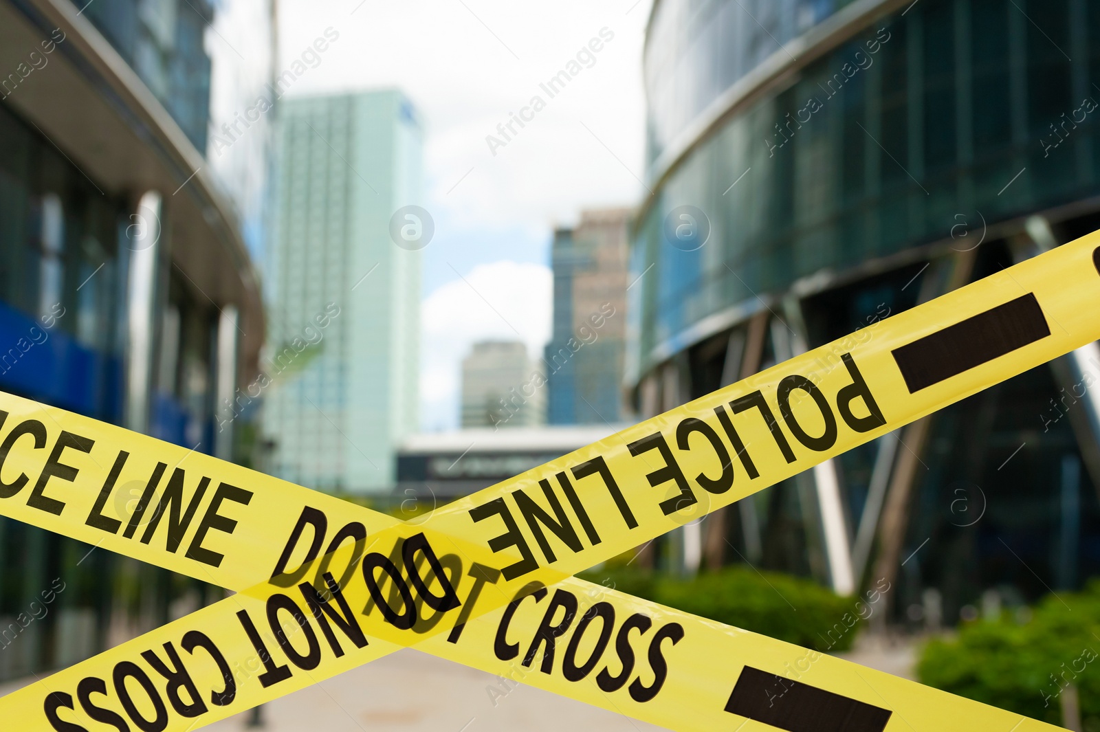 Image of Yellow crime scene tape blocking way on street