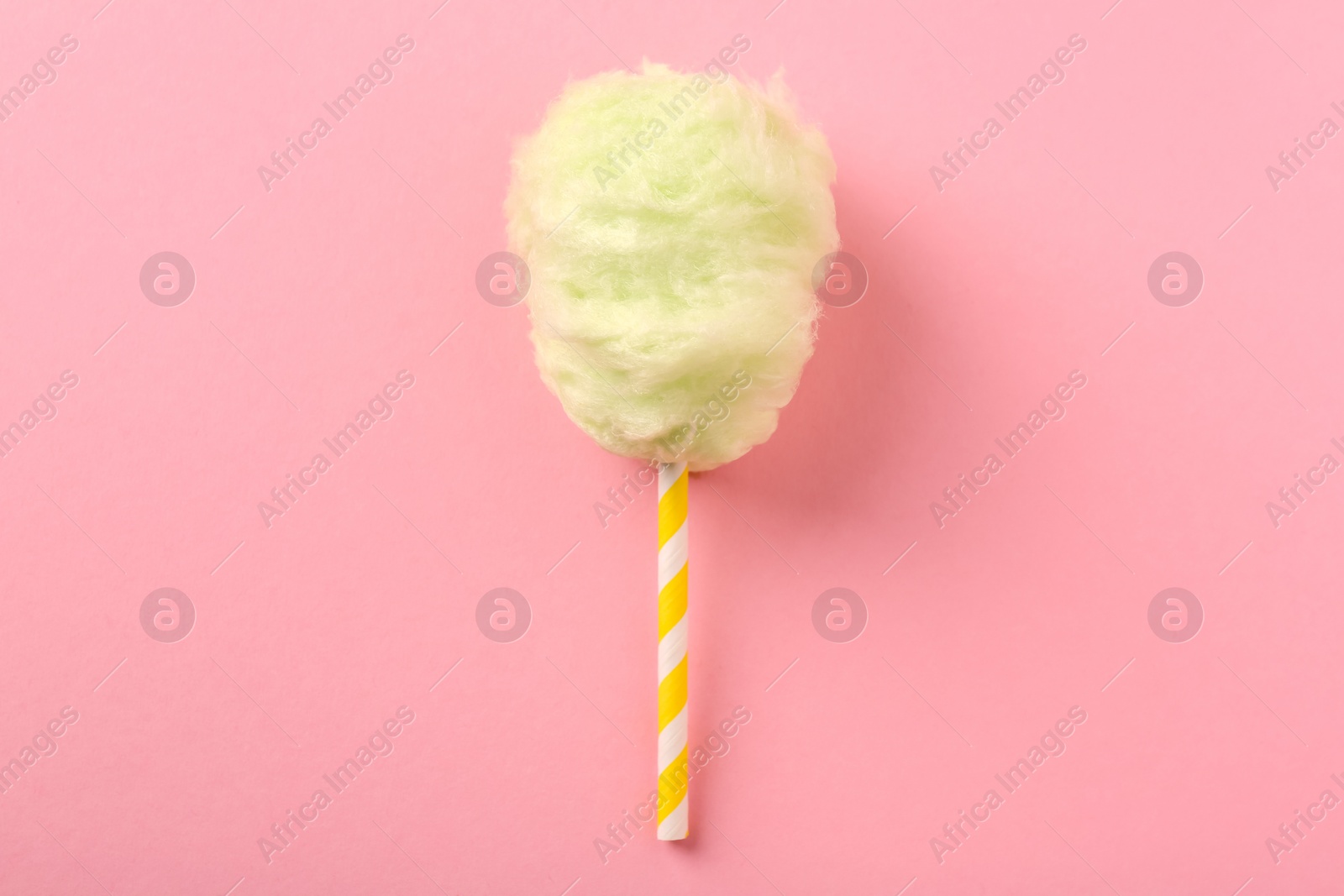 Photo of Sweet cotton candy on pink background, top view