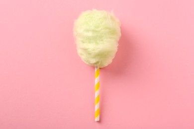 Photo of Sweet cotton candy on pink background, top view