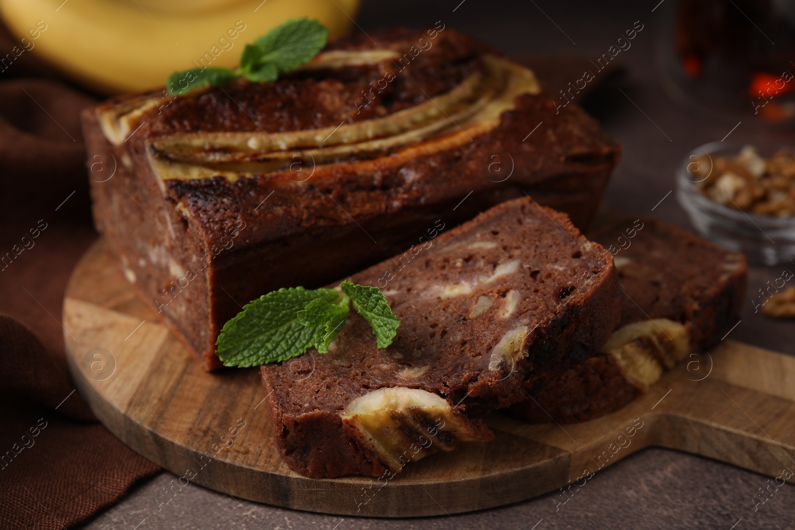 Photo of Delicious banana bread on brown table, closeup