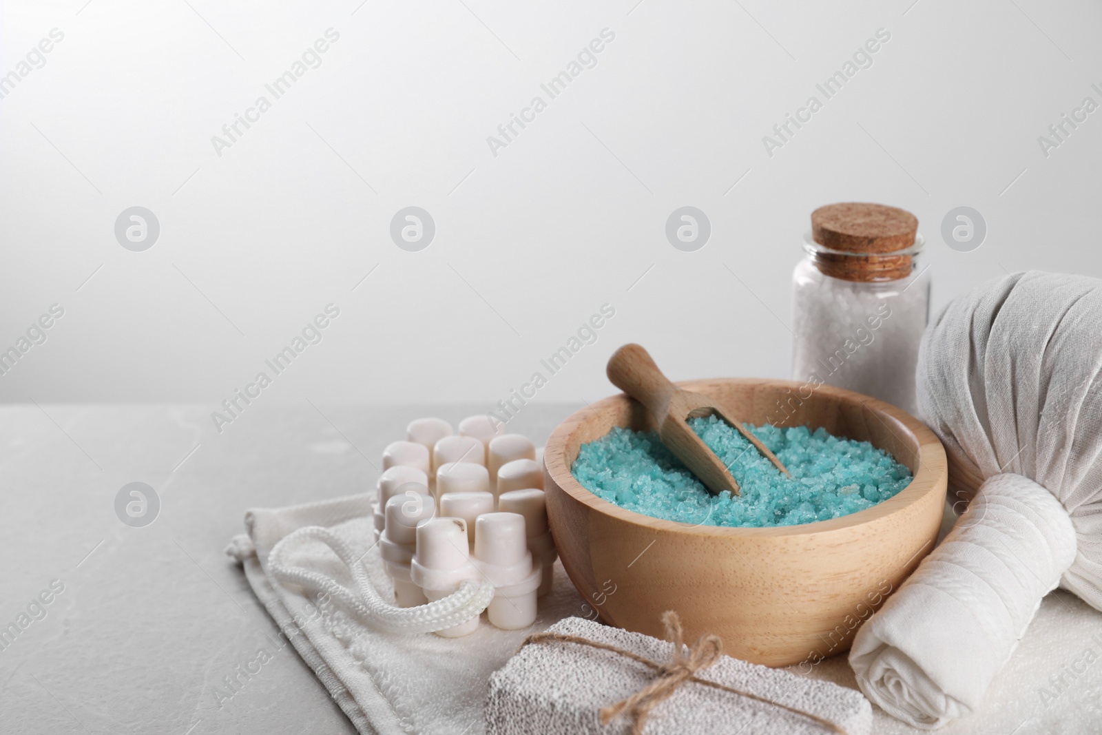 Photo of Spa composition with care products on light grey marble table. Space for text