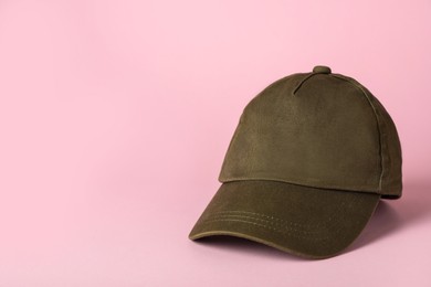 Baseball cap on pink background, space for text