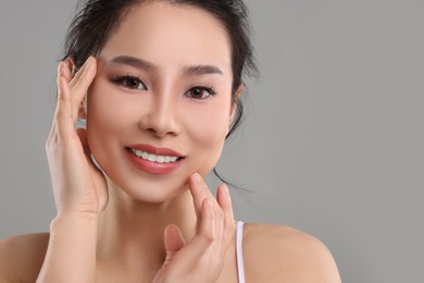 Portrait of beautiful woman on grey background