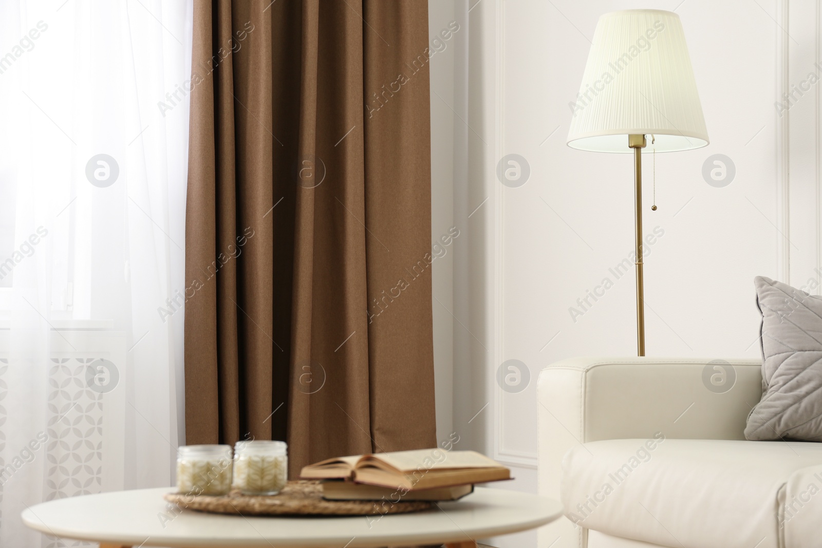 Photo of Modern furniture and window with curtains in stylish room interior