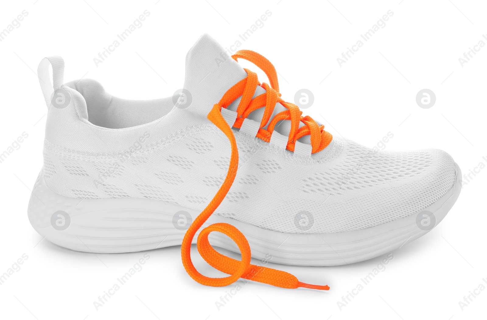Photo of Stylish sneaker with orange shoelaces on white background