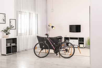 Photo of Light living room interior with modern bicycle