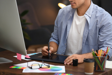 Photo of Male designer working at desk in office, closeup