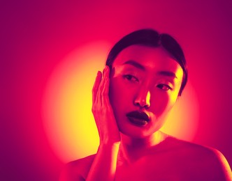Image of Portrait of beautiful Asian woman in neon lights
