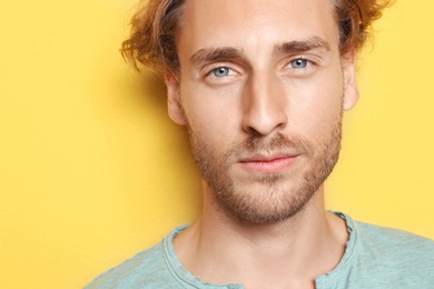 Portrait of young man on color background