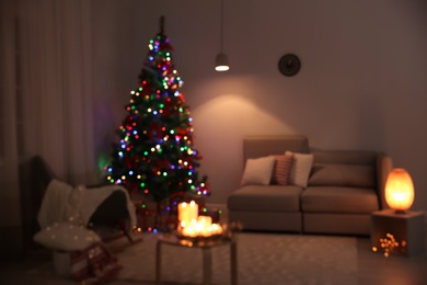 Photo of Blurred view of stylish room interior with decorated Christmas tree