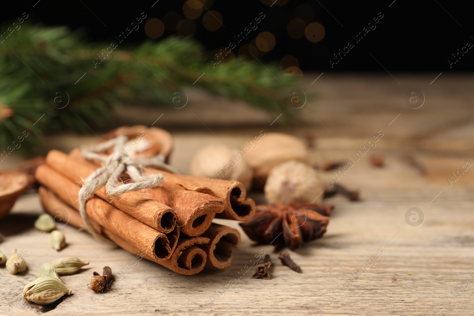 Photo of Different spices on wooden table, closeup. Space for text