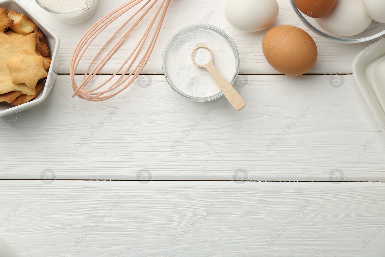 Photo of Flat lay composition with baking powder and products on white wooden table. Space for text