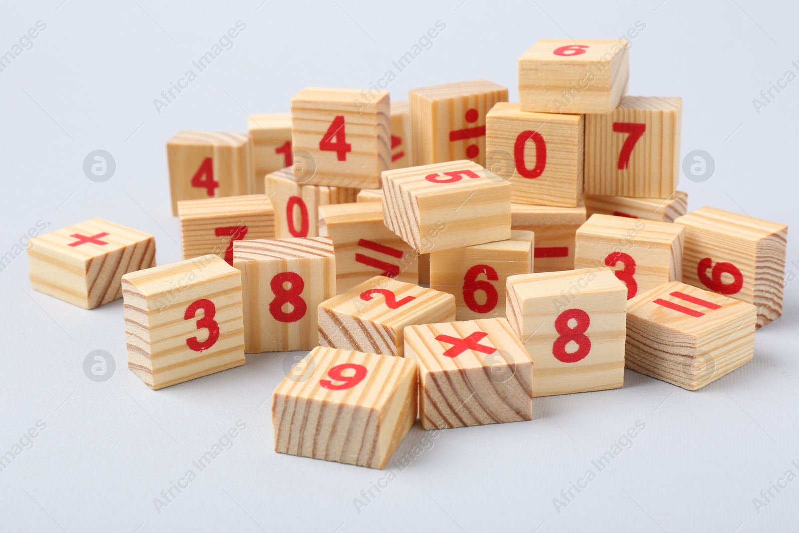 Photo of Wooden cubes with numbers and mathematical symbols on light background