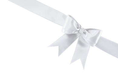 Silver satin ribbon with bow on white background, top view