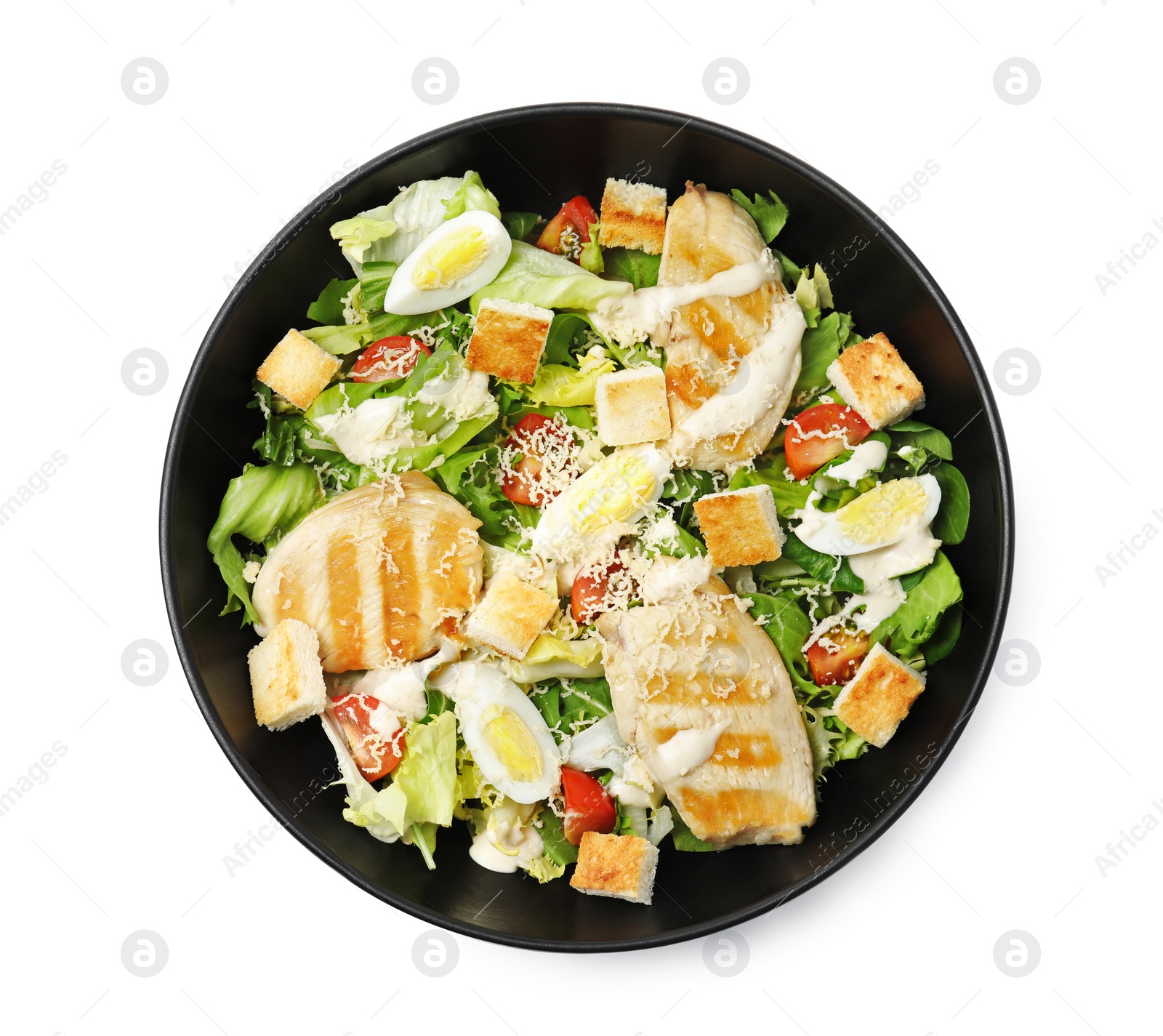 Photo of Delicious Caesar salad in bowl isolated on white, top view