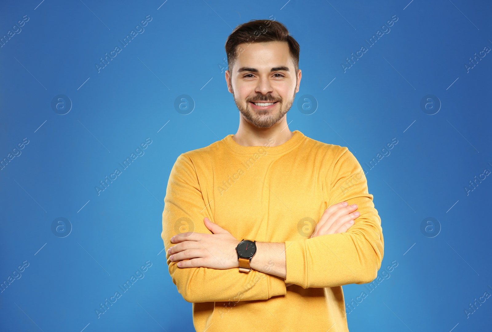 Photo of Portrait of handsome young man on color background