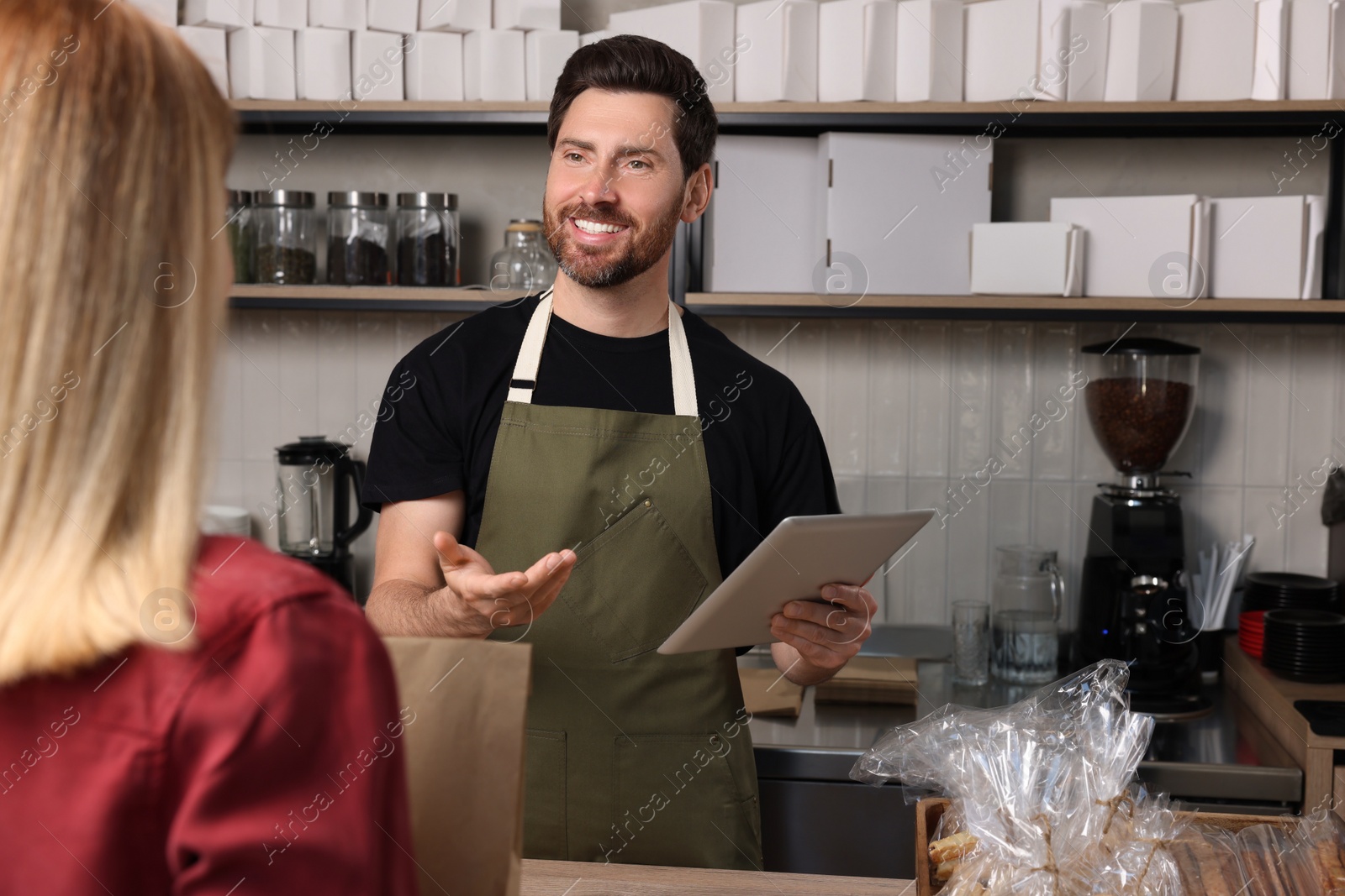 Photo of Woman buying fresh pastries in bakery shop, closeup