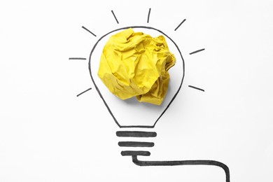 Photo of Creative idea. Drawing of glowing lightbulb and crumpled yellow paper on white background, top view