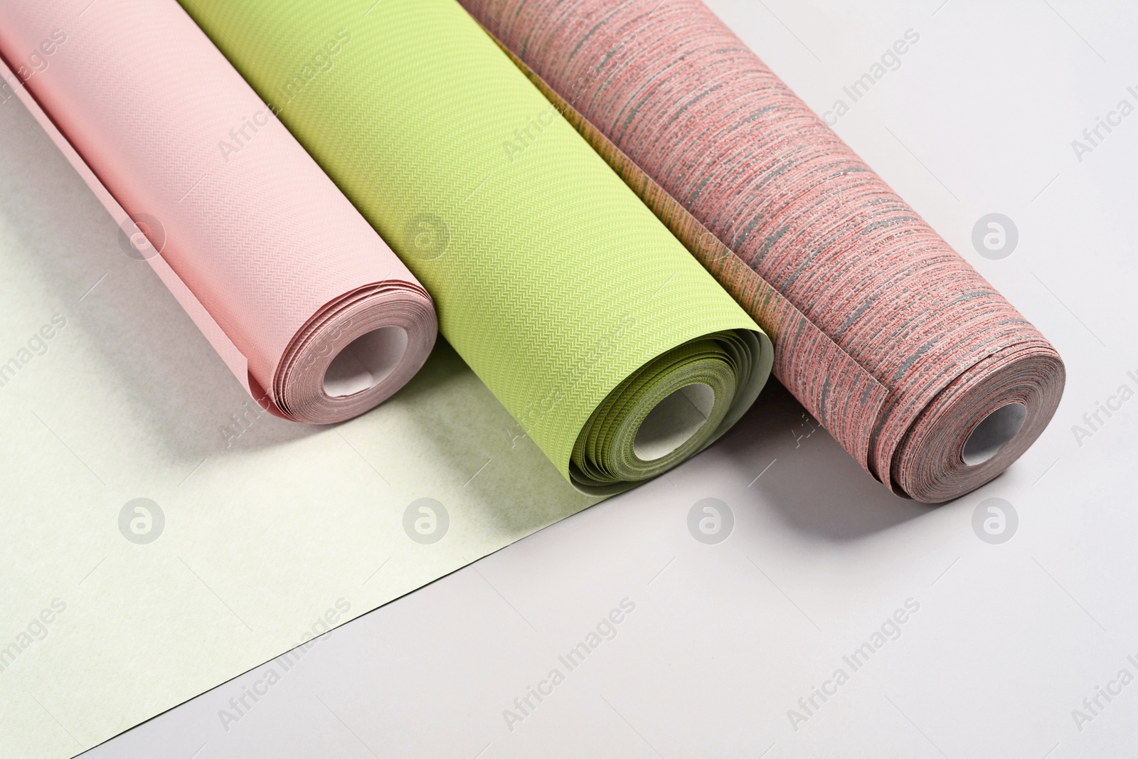 Image of Different wallpaper rolls on light grey background