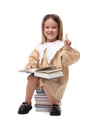Photo of Cute little girl sitting on stack of books against white background