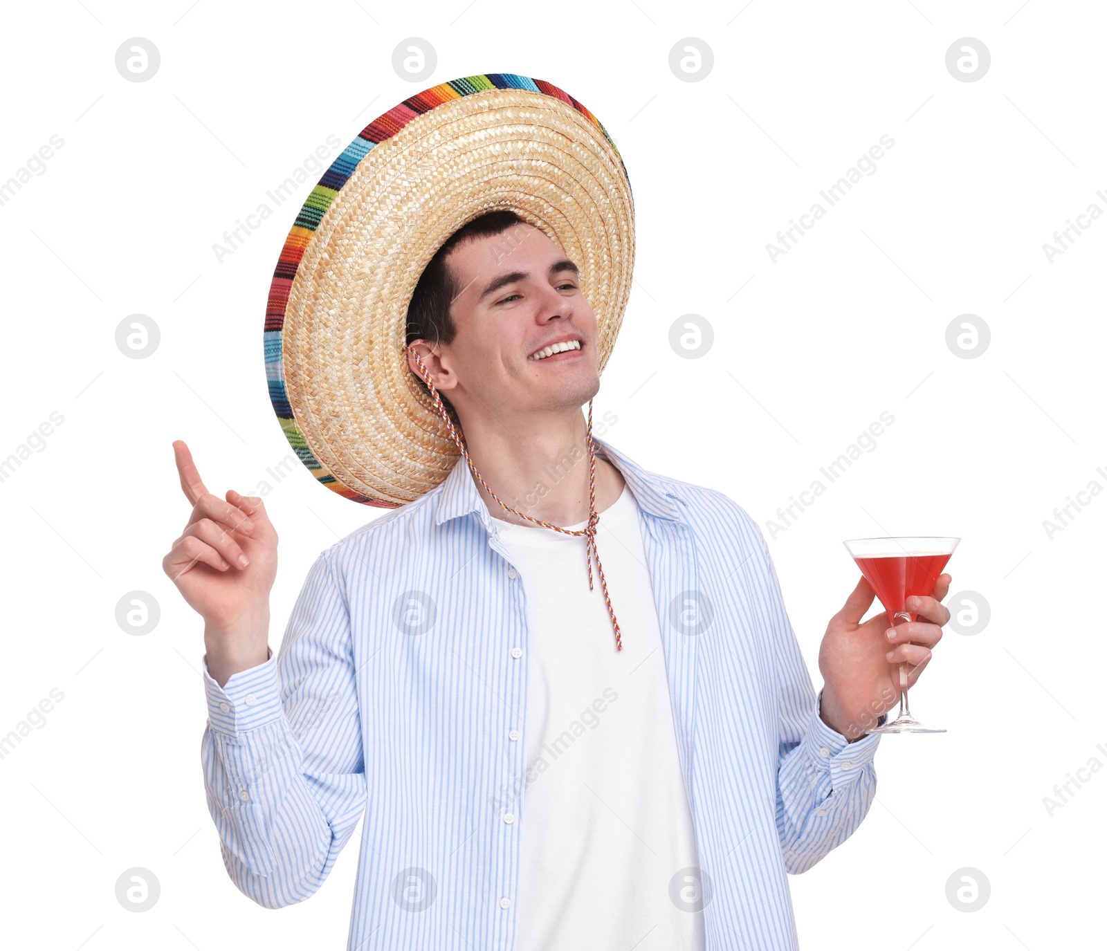 Photo of Young man in Mexican sombrero hat with cocktail on white background