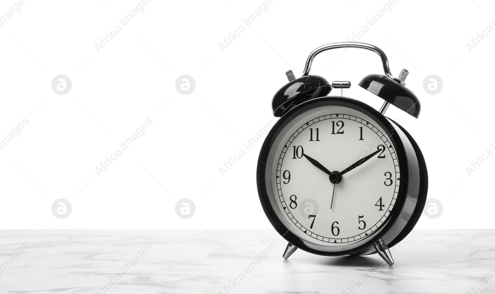 Photo of Alarm clock on table against white background. Time concept