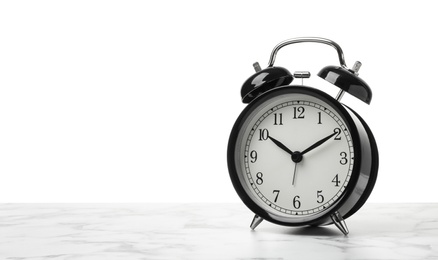 Photo of Alarm clock on table against white background. Time concept