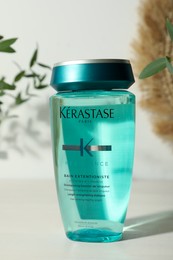 MYKOLAIV, UKRAINE - SEPTEMBER 07, 2021: Kerastase shampoo on white table. Hair care cosmetic product