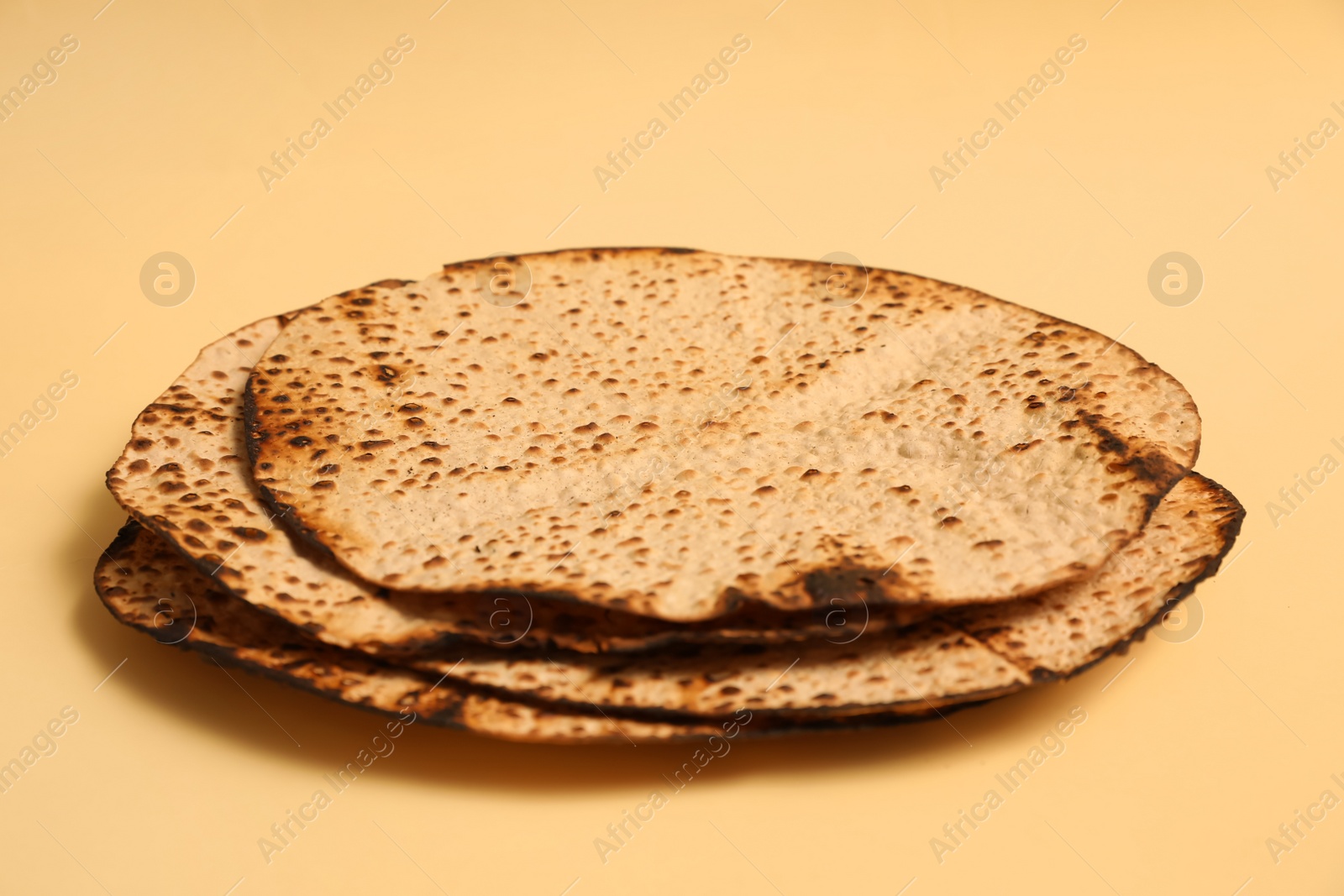 Photo of Tasty matzos on beige background. Passover (Pesach) celebration